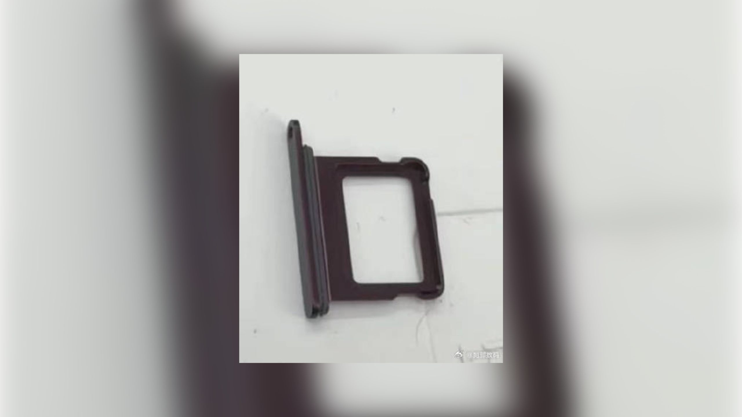 Reference image for: Alleged iPhone 18 Pro Sim Tray Again Shows Dark Cherry Color